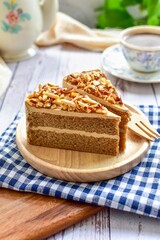 Coffee cake on a wooden plate with wooden fork and  a cup of coffee, morning breakfast
