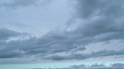 Fluffy layered clouds sky atmosphere. Majestic amazing blue sky with clouds. White and blue colors. Timelapse.