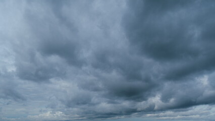 Dramatic sky. Sometimes heavy clouds mass charged. Dark stormy sky with gray cumulus rain clouds. Timelapse.