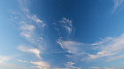 Cirrus clouds flying slowly on beautiful blue sky horizon background. Timelapse.
