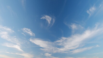 Cloud nature background. Blue sky with cirrus clouds and sun. Nature background of airy cloudscape....