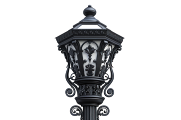 Ornate black lamppost against a white wall. The lamppost features intricate scrollwork and a decorative finial.