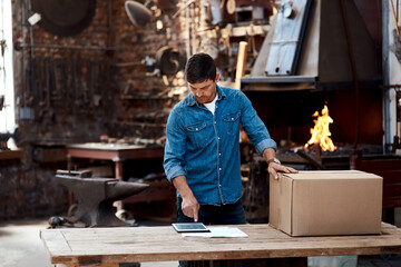 Tablet, box and man in workshop for delivery, blacksmith or manufacturing trade in small business....