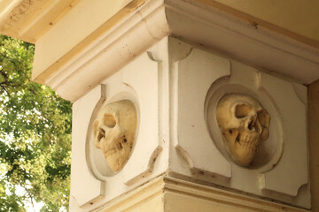Two skull carvings, sculptures, reliefs on a pillar, column, facade of the chapel around the Skull...
