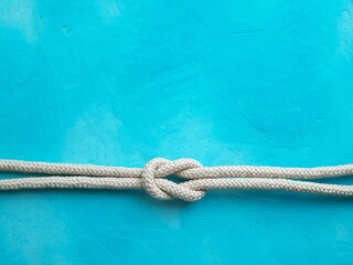 Rope knot on blue background