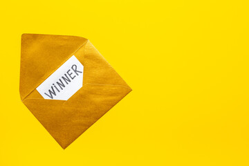 Lottery winner ticket or congratulatory letter on golden letter envelope. Winner concept.