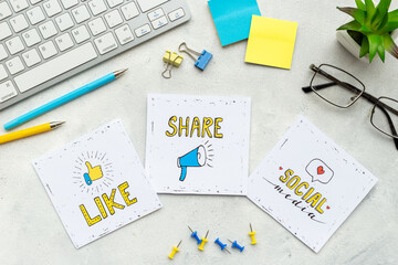 Like repost idea social media icon with keyboards and stationery, top view
