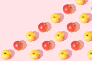  A shiny apple against an isolated pastel pink background, minimal healthy fruits idea on pink background. Apple fruit pattern. Copy space.