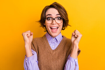 Portrait of ecstatic woman wear knit waistcoat in glasses clenching fists win betting scream yeah...