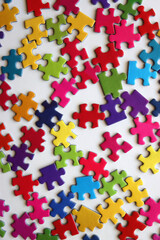 Colorful jigsaw puzzle pieces on white background. Flat lay.