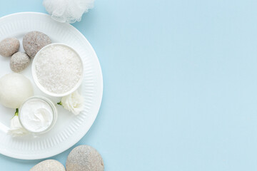 White roses and stones with skin care cosmetics products. Mock up, top view