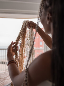 Anonymous woman looking at hair extensions