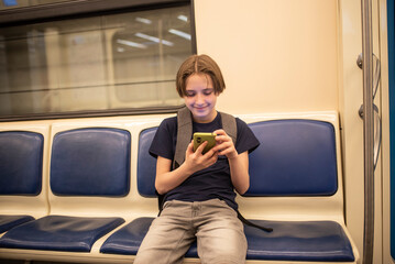 boy with smartphone in the subway