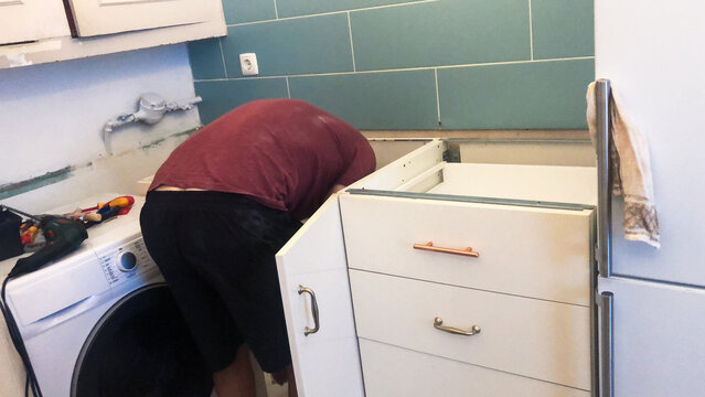 UGC anonymous plumber working in the kitchen