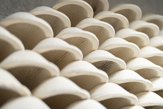 Lot of clay forms for baking lie on each other