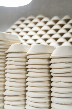 Lot of clay forms for baking lie on each other