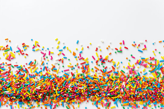 colorful sprinkles border on white background with free space for text