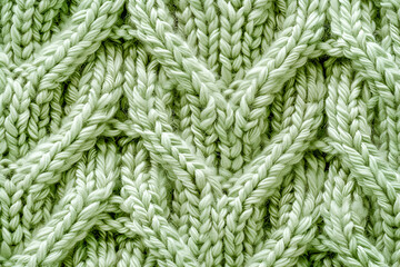 Light green knitted background. Knitting pattern