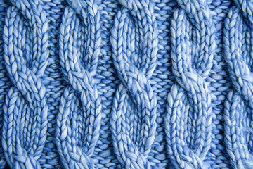 Light blue knitted background. Knitting pattern