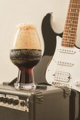 Beer and guitar. Tube combo or amplifier for guitar with electric guitar and glass of stout beer....