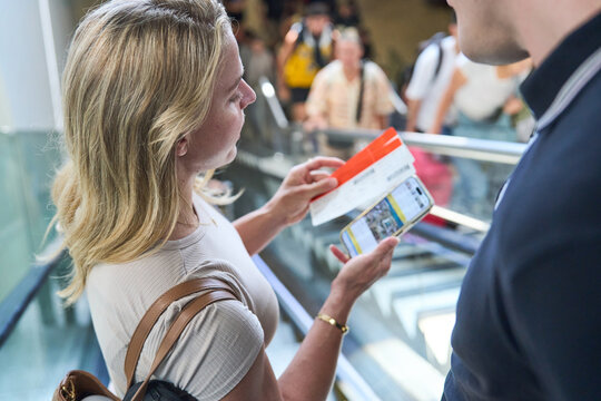 Woman checking her boarding pass details
