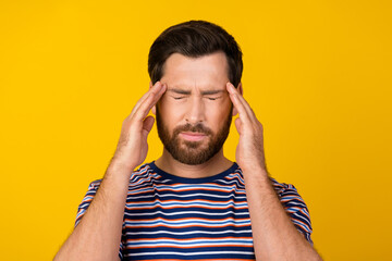 Photo of suffering man with stylish beard dressed striped t-shirt holding hands on head have...