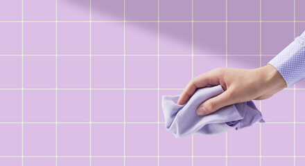 Female hand holding a cleaning cloth