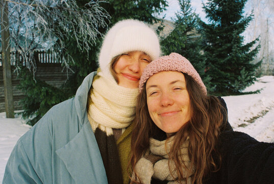 Selfie of young happy women opposite the spruce trees in the village
