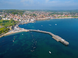 Fototapeta premium Swanage, Dorset. United Kingdom. Spring time Aerial image of one of Southern Englands finest coastal Towns. 9th May 2024