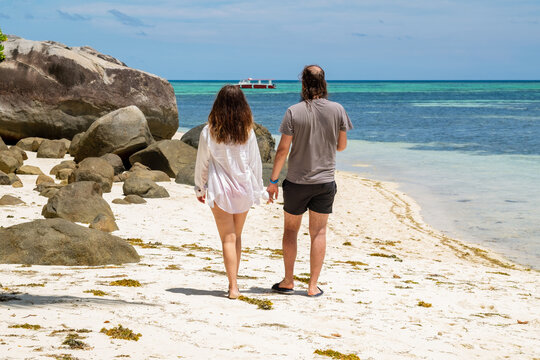 Couple walking on the beach in Seychelles