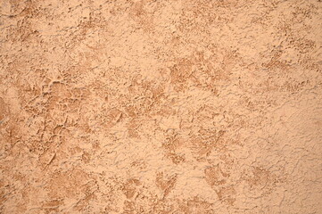 Textured background of brown and beige plaster