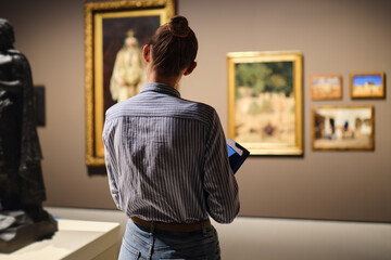 visitor in historical museum looking at art object