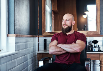 Barber, thinking and man by window for hair grooming, wellness and beard service in chair....