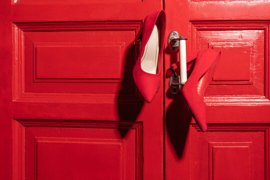 Red High Heels on Red Door