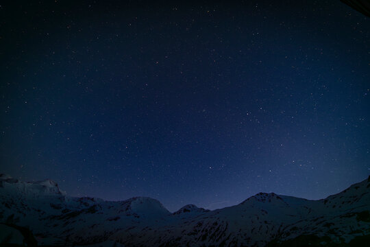 Night blue sky in spring evening with snow and star lights