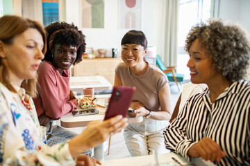 Diverse female business colleagues taking a selfie in office