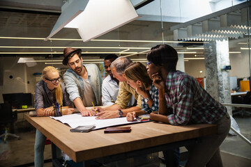 Diverse team of architects collaborating on a project in a modern office setting