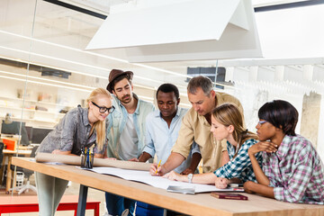 Diverse team of architects collaborating on a project in a modern office setting