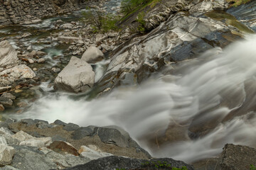 Waterfall in spring evening in valley of river Diveria in Gondo village