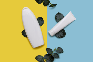 White container and cosmetic cream on a paper background. With eucalyptus leaves.