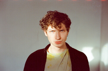 Portrait of model with bedhead waking up making eye contact camera
