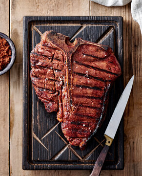 T-bone steak on a serving board