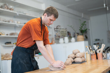 Potter kneads clay before using it in the workshop. 