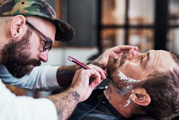 Beard, hair and barber with customer for shave, haircut and grooming for hygiene, wellness or...