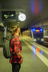 Young Man watching the a train arriving to the platform