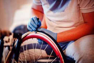 Close-up of a mechanic in blue gloves fixing a bicycle tire, emphasizing the precision and care in...