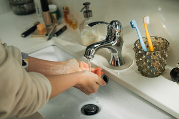 Unrecognizable woman washing hands