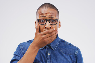 Fototapeta premium Studio portrait, black man and shock for gossip with wow, fake news and drama or secret announcement. African male person, surprised and oops emoji for mistake and reaction by white background