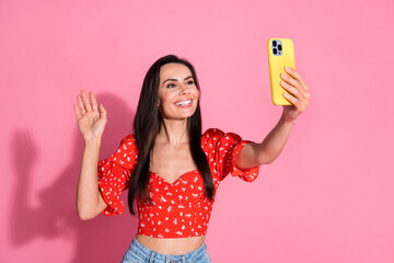 Photo of brunette hair hispanic young smiling lady in bright red stylish blouse using smartphone...
