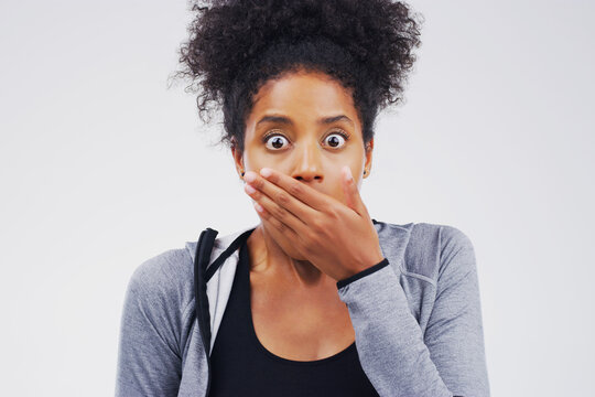 Studio portrait, black woman and surprised for gossip with wow, fake news or information and secret announcement. African girl, shock and oops emoji for lottery and meme reaction by white background